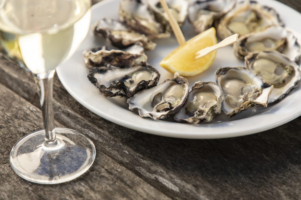 Freshly served oysters with lemon and wine